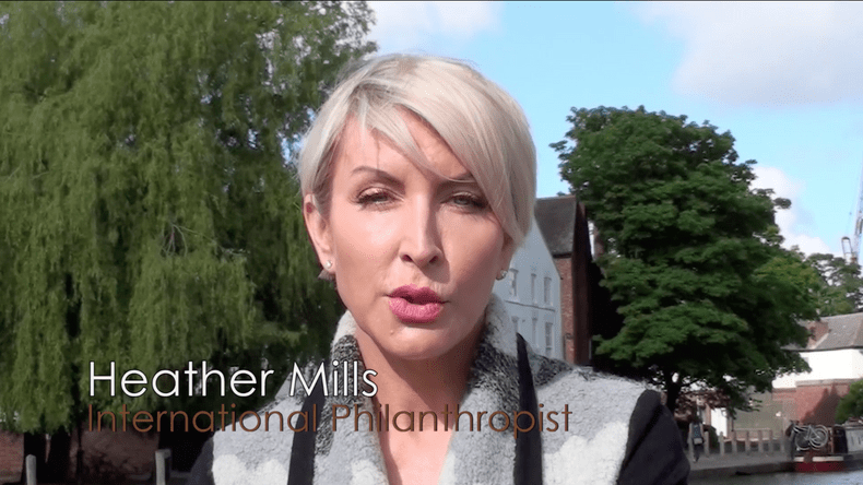 Heather Mills looks to the camera with the caption: Heather Mills International Philanthropist