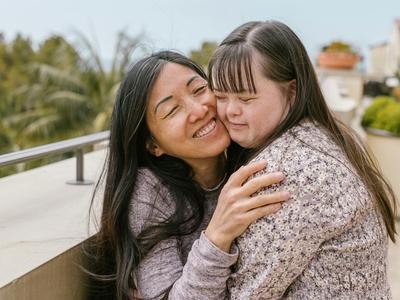 A mother and daughter embrace in a hug.